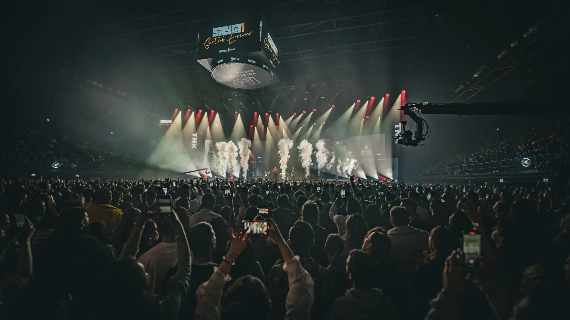 From the back of the arena: a sea of raised phones, smoke jets firing on stage